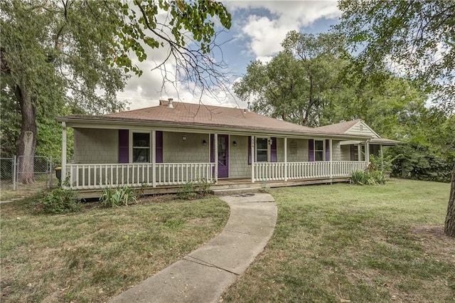 single story home with a front lawn and covered porch