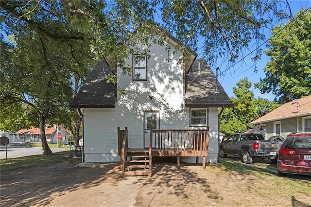 back of house featuring a deck