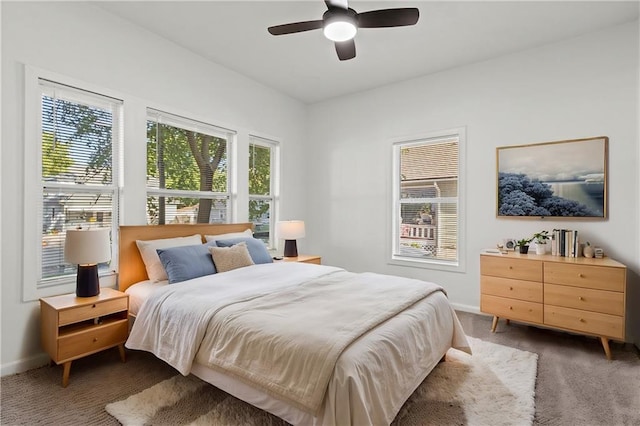 bedroom featuring dark carpet and ceiling fan