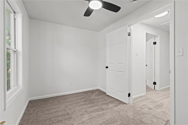 empty room with light colored carpet and ceiling fan