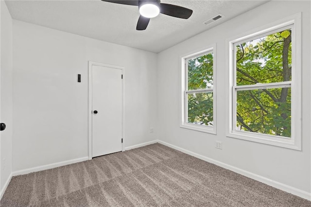 empty room featuring ceiling fan and carpet flooring