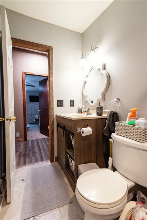 bathroom with hardwood / wood-style floors, vanity, and toilet