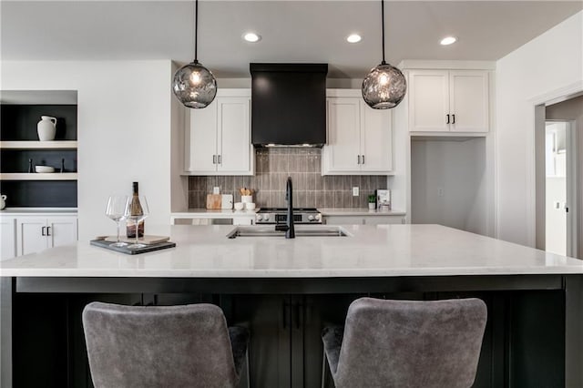 kitchen with a spacious island, sink, and hanging light fixtures