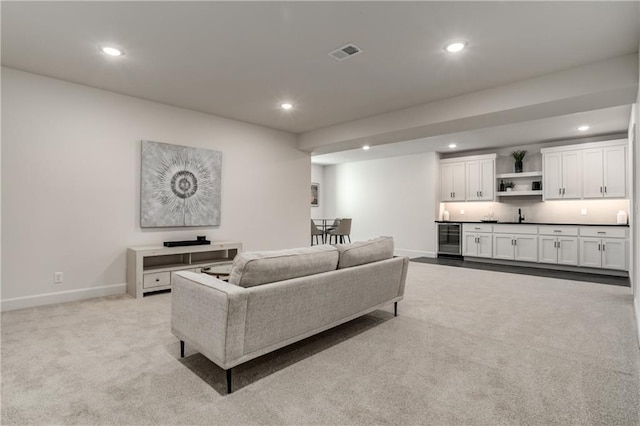 living room featuring light colored carpet and beverage cooler