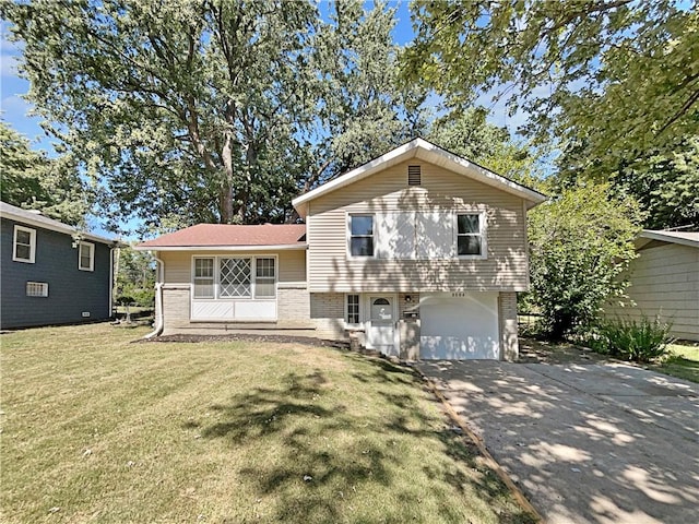 tri-level home with a garage and a front yard