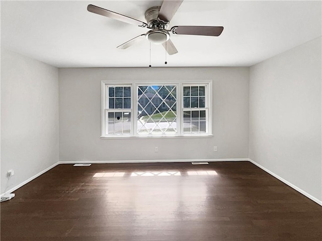 unfurnished room featuring a ceiling fan, baseboards, and wood finished floors