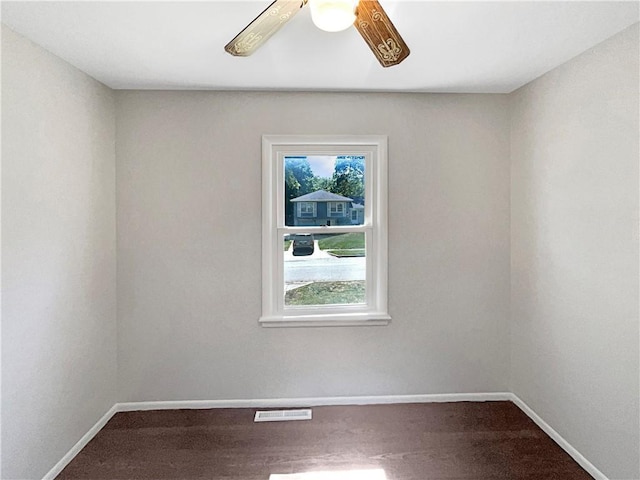 empty room featuring visible vents, plenty of natural light, and baseboards