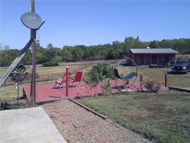 view of yard with a deck and an outbuilding