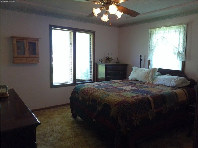 27061 Willow Dr, Paola, KS 66071 - bedroom featuring light carpet, ceiling fan, and baseboards