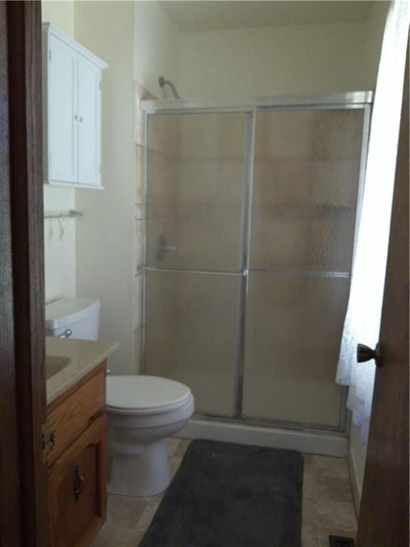 27061 Willow Dr, Paola, KS 66071 - bathroom featuring a stall shower, vanity, toilet, and tile patterned floors