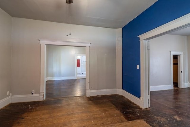 unfurnished room featuring dark wood-type flooring