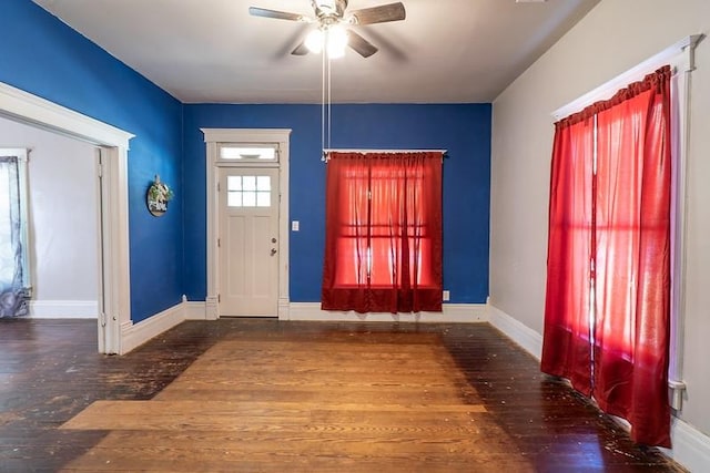 foyer entrance with ceiling fan and dark hardwood / wood-style floors