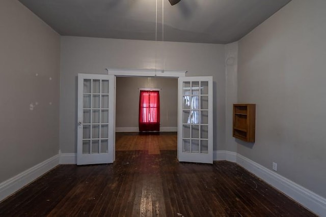 spare room featuring ceiling fan, dark hardwood / wood-style floors, and french doors