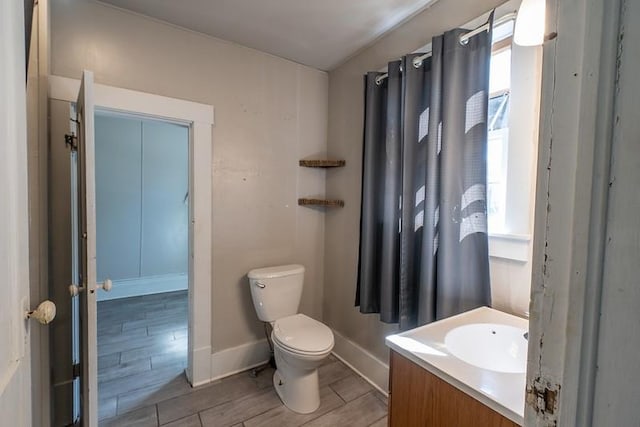 bathroom featuring vanity, toilet, and hardwood / wood-style floors