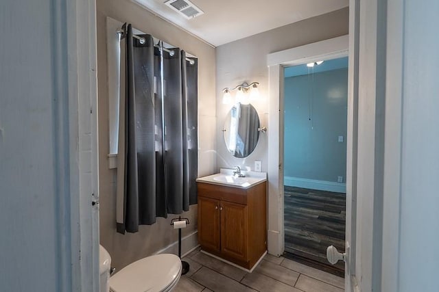 bathroom featuring hardwood / wood-style floors, toilet, and vanity