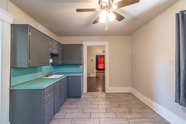 kitchen featuring sink, ceiling fan, and light hardwood / wood-style floors