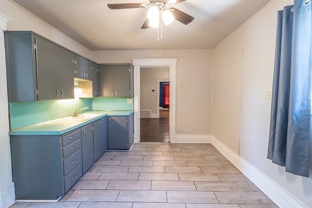 kitchen featuring light wood-type flooring, sink, and ceiling fan