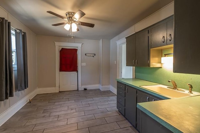 kitchen featuring light wood-type flooring, sink, and ceiling fan