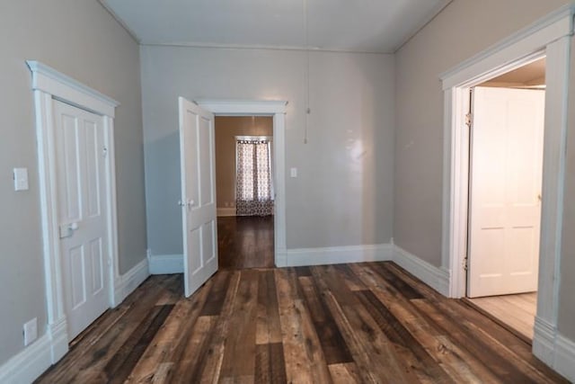 empty room with dark hardwood / wood-style floors