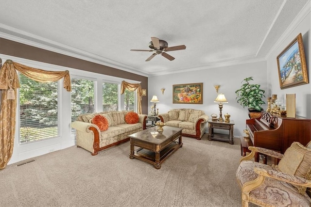 living room featuring ceiling fan, a textured ceiling, light carpet, and a healthy amount of sunlight