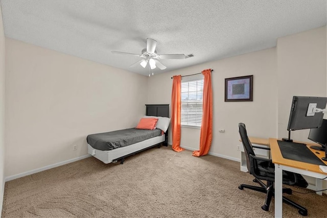 bedroom with ceiling fan, carpet, and a textured ceiling