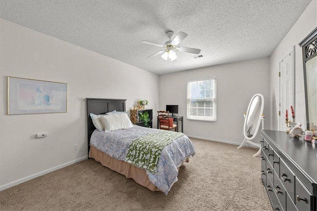 carpeted bedroom with a textured ceiling and ceiling fan