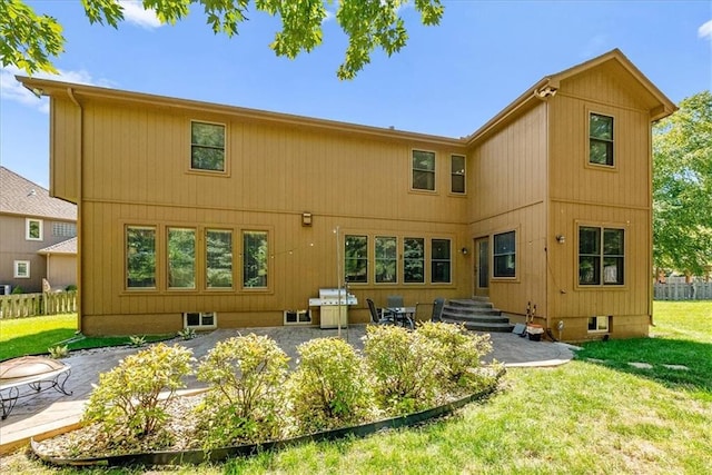 back of property featuring a yard and a patio