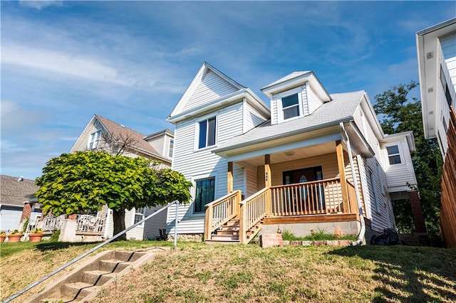 view of front of home with a porch and a front lawn