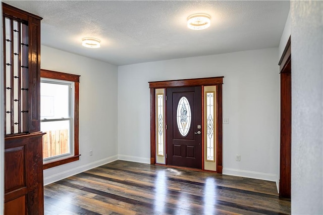 entryway featuring a textured ceiling and dark hardwood / wood-style floors