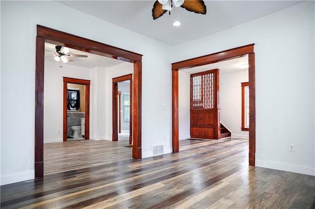 spare room with dark hardwood / wood-style flooring and ceiling fan