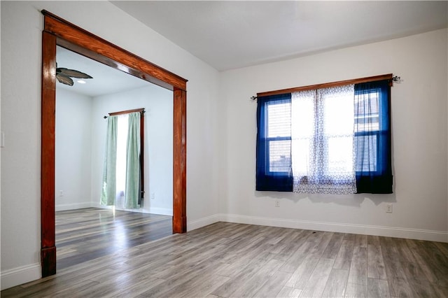 spare room with hardwood / wood-style floors and ceiling fan