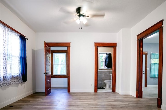 unfurnished room with ceiling fan and hardwood / wood-style flooring