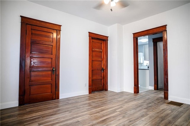 unfurnished bedroom with hardwood / wood-style floors and ceiling fan