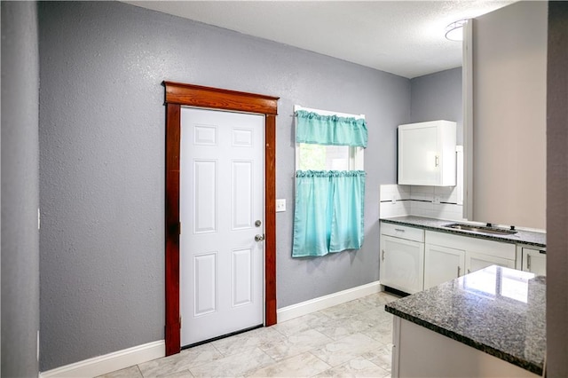 interior space featuring vanity and a textured ceiling