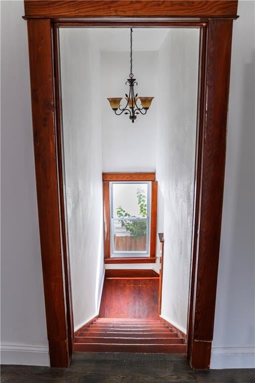 interior space with dark wood-type flooring and a chandelier