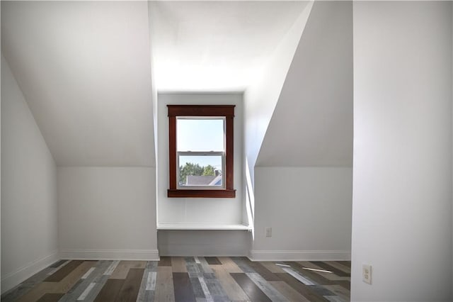 additional living space with lofted ceiling and dark hardwood / wood-style flooring