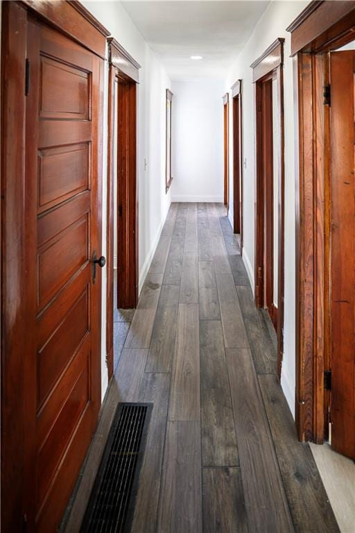 hallway with dark hardwood / wood-style floors