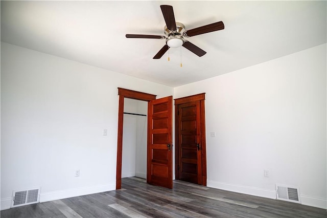 unfurnished bedroom featuring ceiling fan and dark hardwood / wood-style flooring