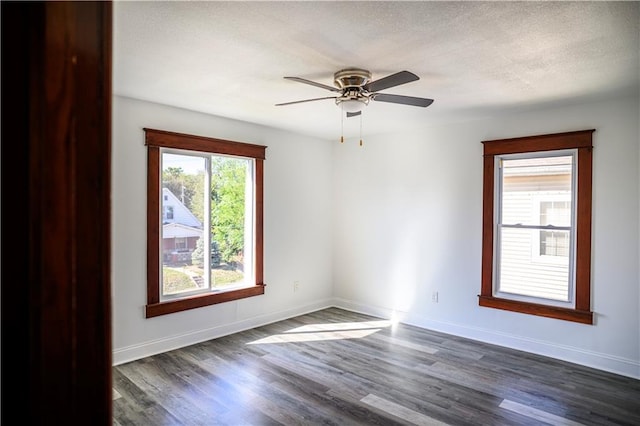 spare room with dark hardwood / wood-style flooring, ceiling fan, and a textured ceiling