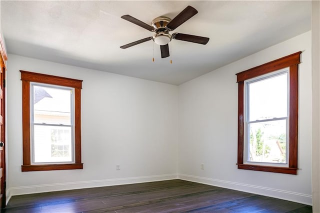 unfurnished room featuring dark wood-type flooring and ceiling fan