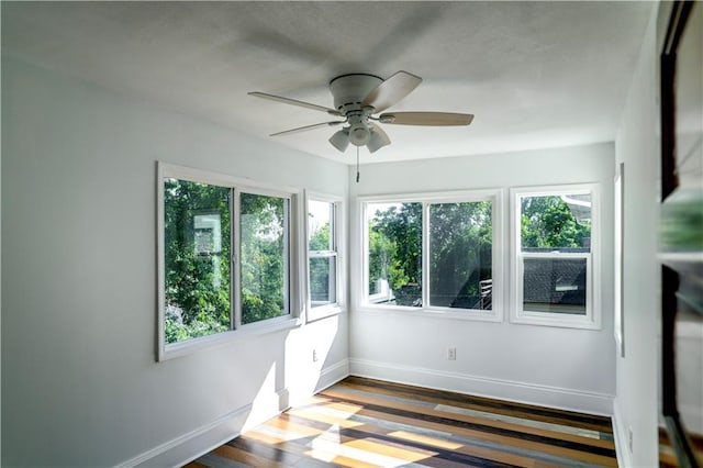 interior space with wood-type flooring and ceiling fan