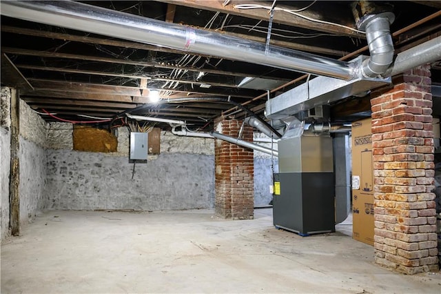 basement featuring heating unit and electric panel