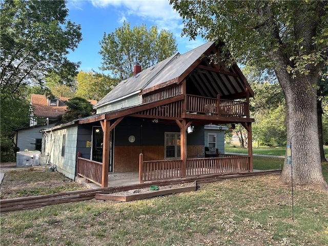 back of house with a wooden deck