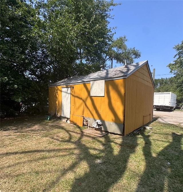 view of outdoor structure with a lawn