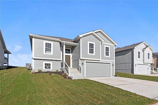 split foyer home with a garage, a front yard, and central AC