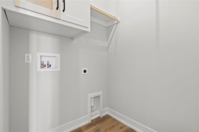 clothes washing area featuring washer hookup, electric dryer hookup, dark hardwood / wood-style floors, and cabinets