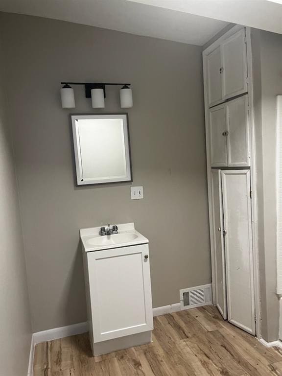 bathroom featuring hardwood / wood-style floors and vanity