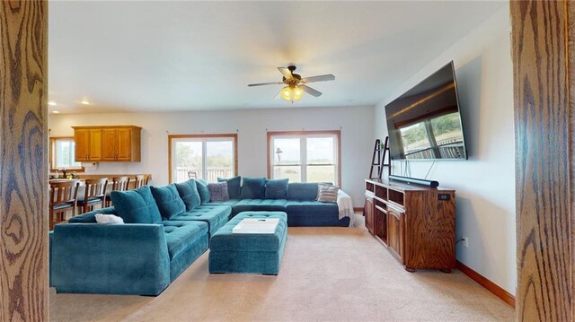 carpeted living room featuring ceiling fan