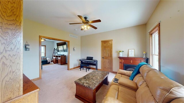 carpeted living room featuring ceiling fan