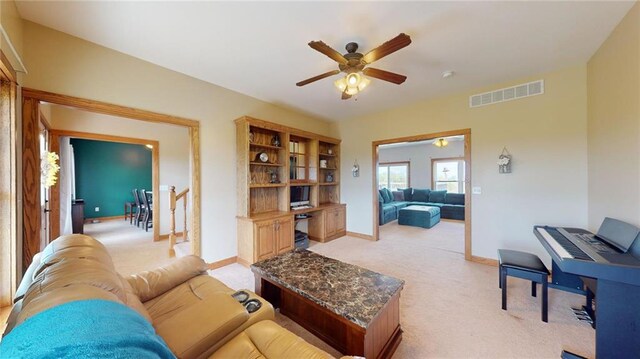 carpeted living room featuring ceiling fan